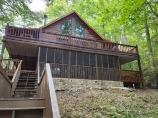 Chalet-style cabin with a screened porch and upper deck