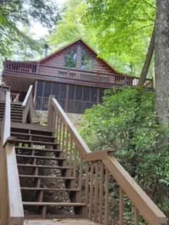 Exterior wood stairs leading up to a chalet deck