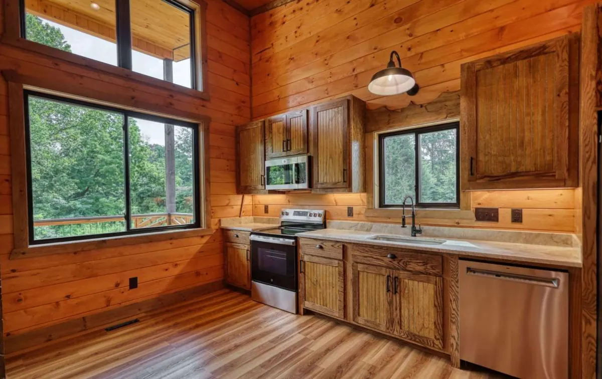 Second kitchen with tall windows and stainless appliances