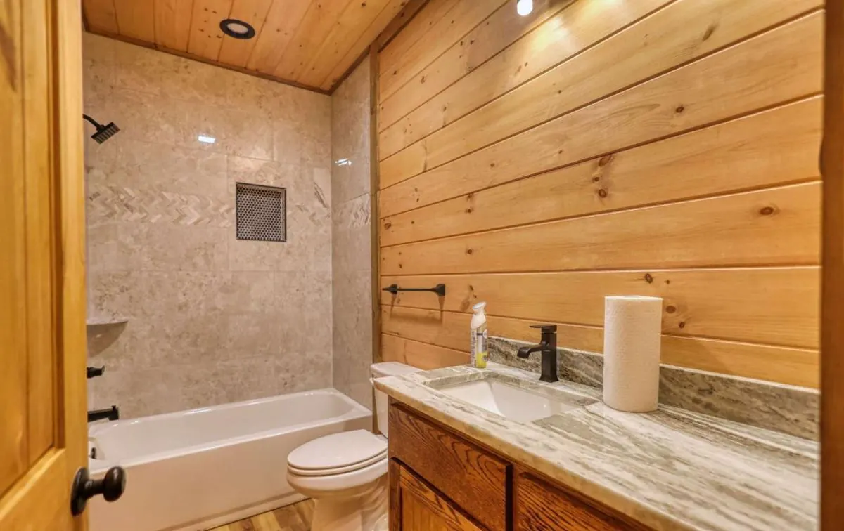 Full bathroom with tub and tile surround