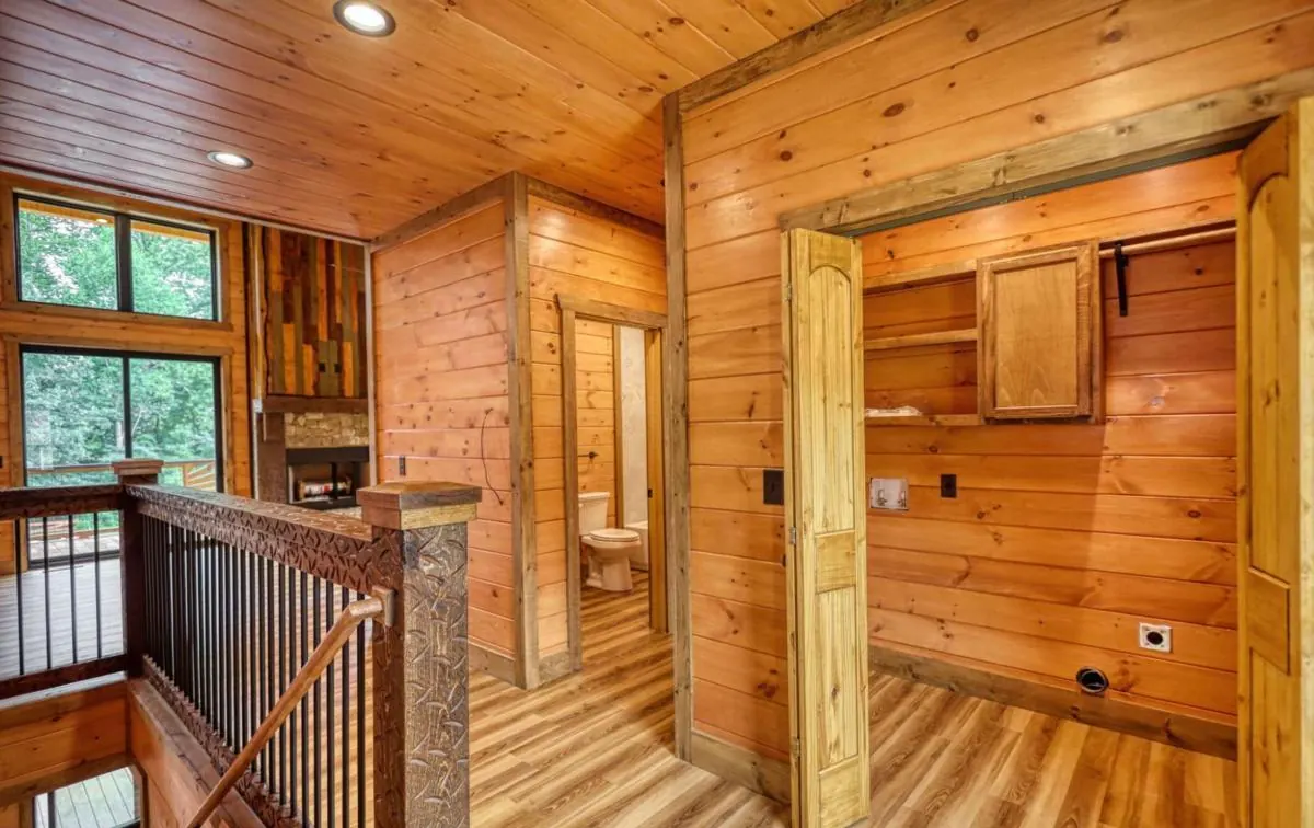 Upstairs landing with stair rail and tall windows