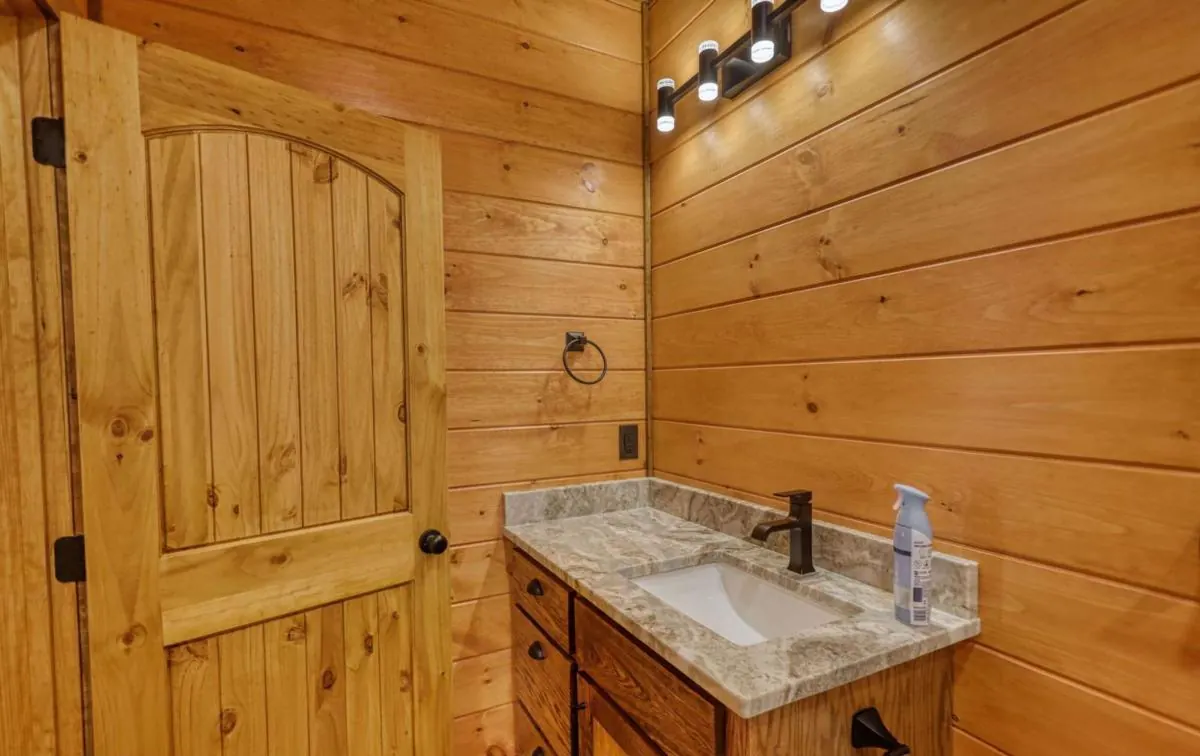 Bathroom vanity with a stone top and black fixtures