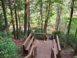 Wood landing with built-in benches above a river